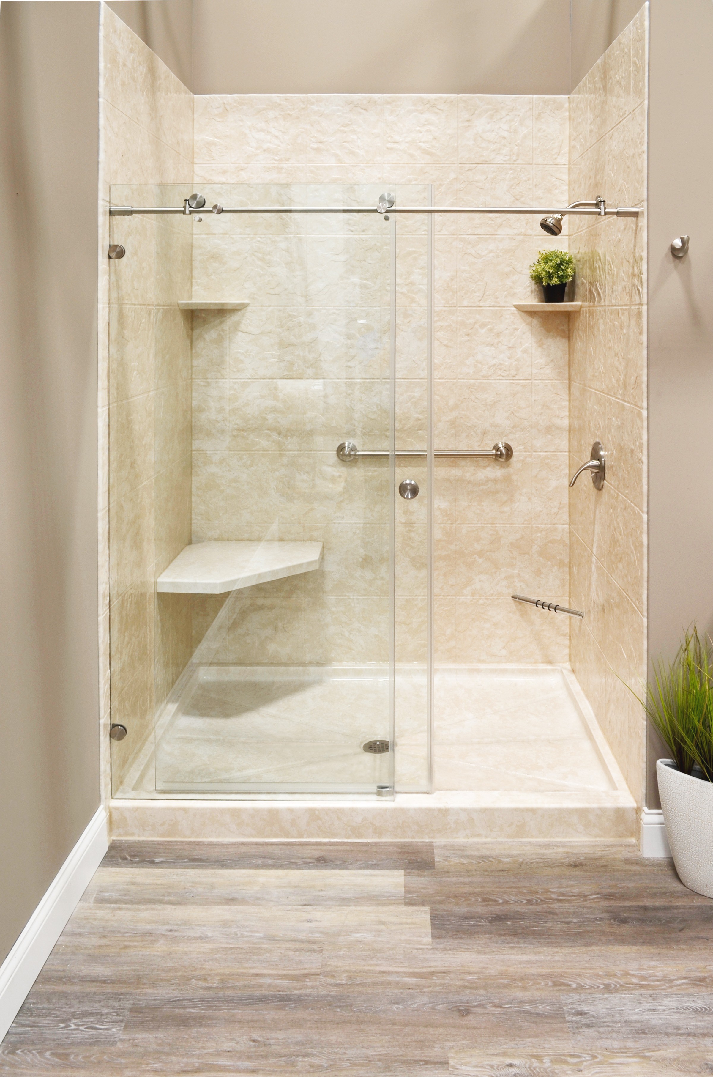 Warm beige tile shower niche with wood-look floor — bathroom transformation