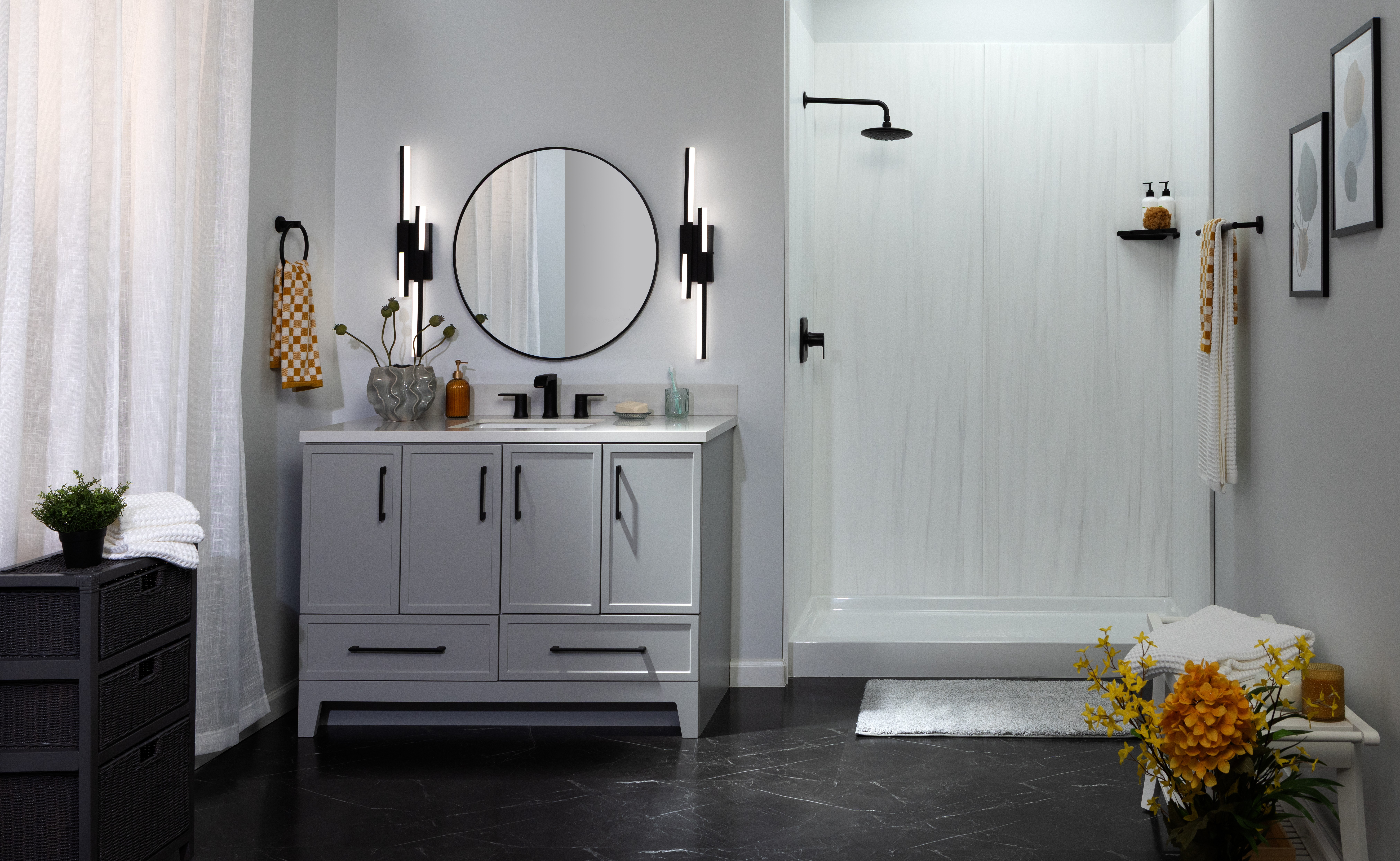 Dark navy vanity with black tile floor and modern fixtures