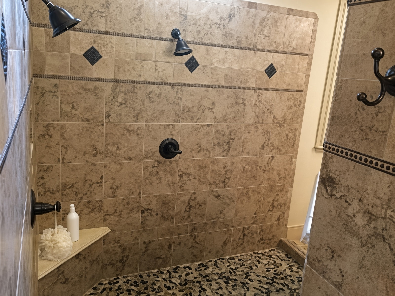 Custom Tuscan Travertine Tile Walk-In Shower with Natural River Rock Floor